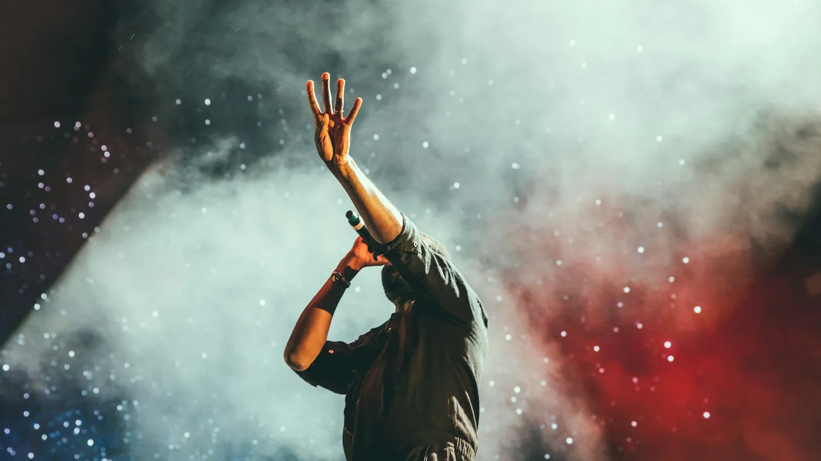 Artist on stage in smoke and lights at a nightlife event